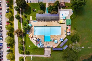 An aerial view of a swimming pool complex with a large pool, multiple slides, and sun loungers. - Hoosier House on S. Park Ave. Newly renovated, Close to IU Campus, (Bloomington)