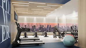 Ett modernt gym med löpband, crosstrainers och träningsbollar.