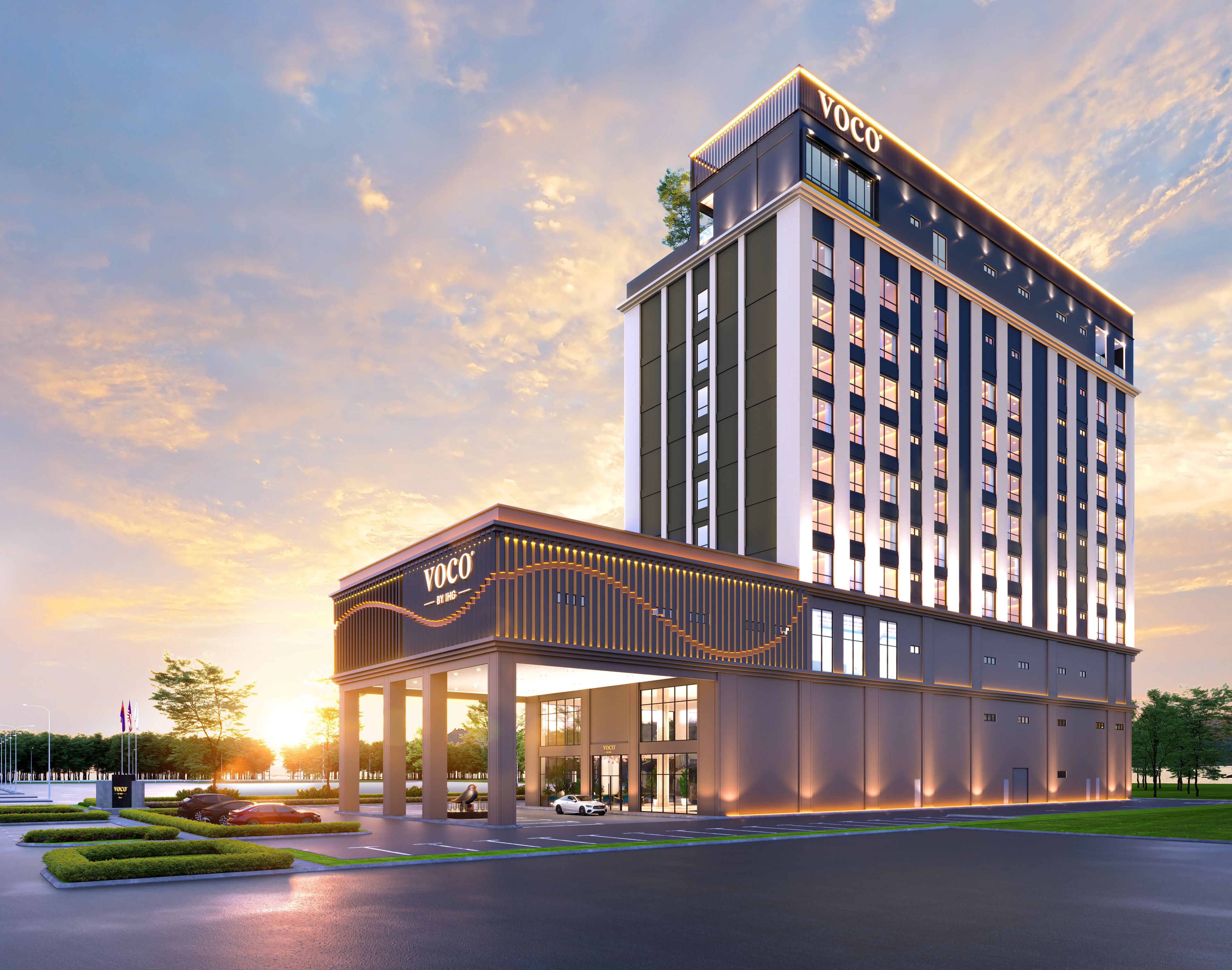 A modern hotel with a prominent entrance, multiple floors, and a clear sky.