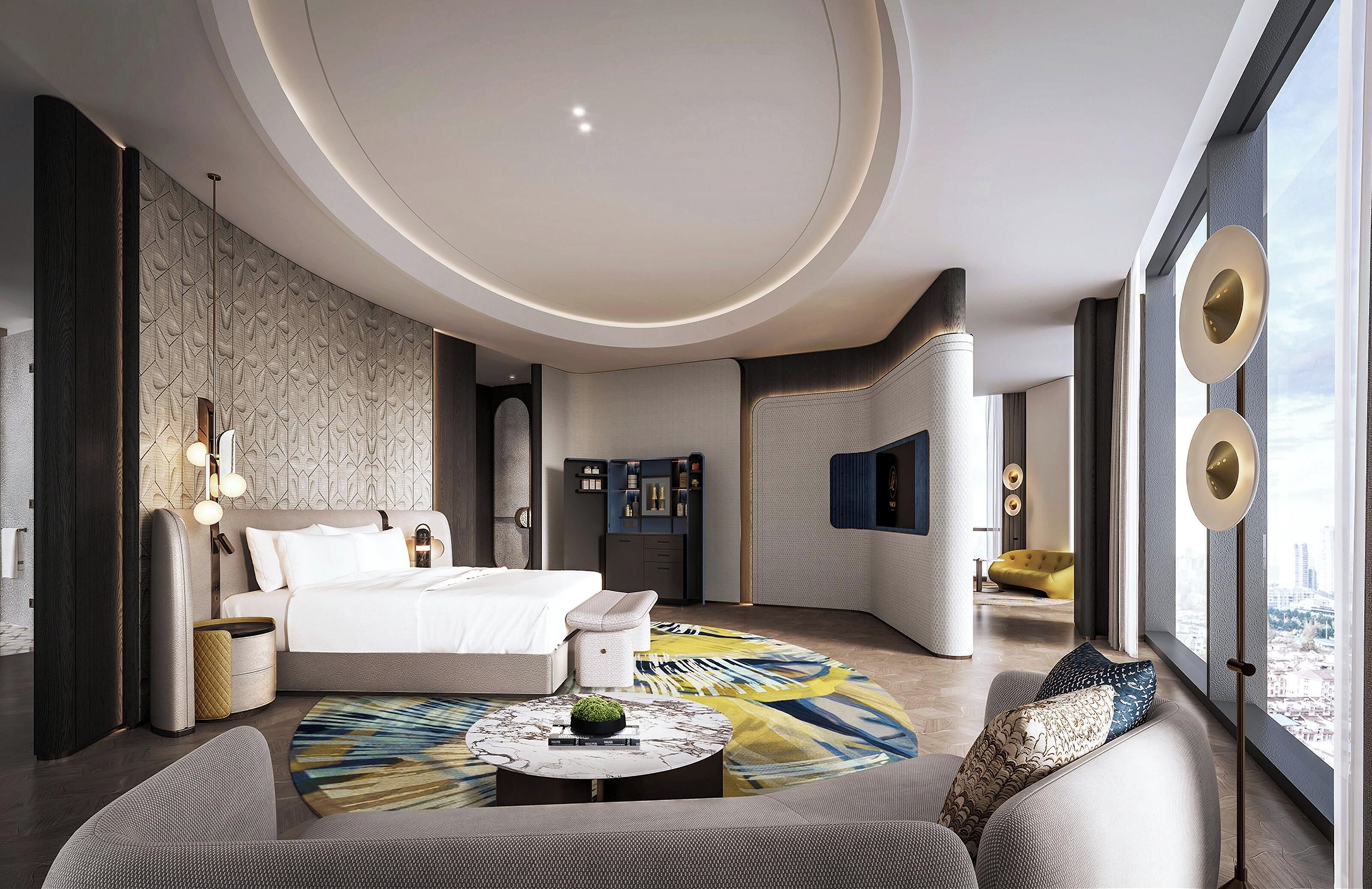 Ein modernes Hotelzimmer mit einem großen Bett, einem runden Couchtisch und Blick auf die Stadt.