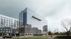 A modern building with a glass facade, a flat roof, and a rectangular shape. - Voco Chengdu Movie Metropolis By Ihg (Chengdu)
