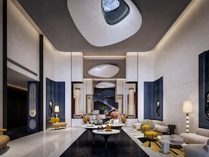 A modern hotel lobby with a central staircase, seating areas, and a large skylight. - Voco Chengdu Movie Metropolis By Ihg (Chengdu)