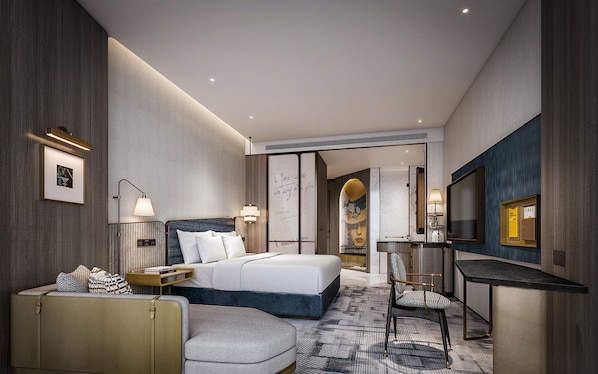 A modern hotel room with a bed, bedside table, lamp, seating area, and a TV. - Voco Chengdu Movie Metropolis By Ihg (Chengdu)