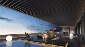 A modern interior with a reflective floor, a lounge area with seating, and a view through a large window. - Voco Chengdu Movie Metropolis By Ihg (Chengdu)