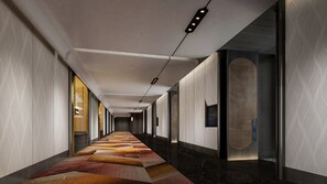 A long hallway with patterned walls, a carpeted floor, and a series of doors on one side. - Voco Chengdu Movie Metropolis By Ihg (Chengdu)