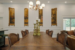 A formal dining room with a long wooden table, ornate chairs, and a chandelier. - Pecan Manor Off Main - Historic Downtown Franklin (Franklin)