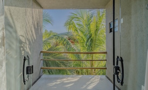 A concrete entrance with a metal gate, leading to a view of palm trees and a clear sky. - House w 3 Suites n Pool 100m From the sea Hva0009 (Passo de Camaragibe)