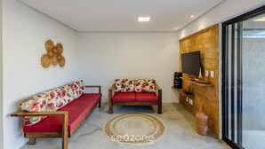 A cozy living area with two sofas, a TV, and a brick wall. - House w/ Pool 100m From the Beach Hva0002 (Passo de Camaragibe)
