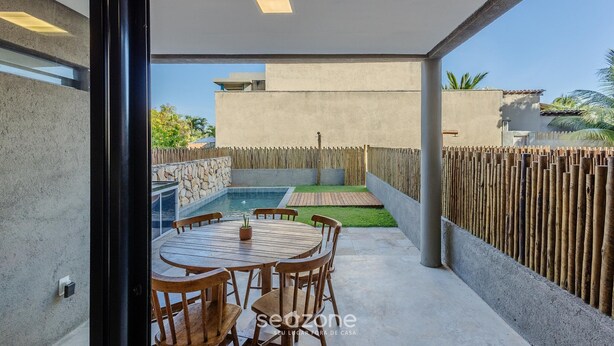 A modern outdoor patio with a round wooden table and chairs, a small pool, and a wooden fence. - House w/ Pool 100m From the Beach Hva0002 (Passo de Camaragibe)