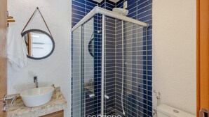 A bathroom with a white sink, a mirror, and a shower with blue tiles. - House w/ Pool 100m From the Beach Hva0002 (Passo de Camaragibe)