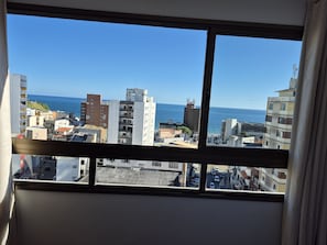 A view from a window overlooking a cityscape with buildings and a clear blue sky. - Studio in Build. w/ Pool, 270m fr the sea Cao0903 (Salvador)