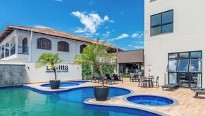 A pool area with lounge chairs and a building labeled 'Lavitta Residence Beach and Park.' - Apt 650m fr/ Beto Carrero in Cond w/ Pool Lav0401 (Penha)