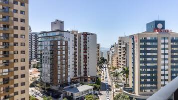 A high-rise hotel with multiple floors, a prominent sign, and a view of the surrounding urban area.