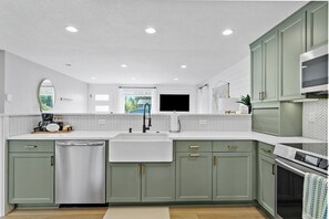A modern kitchen with a dishwasher, sink, and a large window. - 3-Bedroom Ranch Home, Private Yard, Long Driveway (Edmonds)