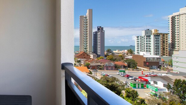 A cityscape with high-rise buildings, a parking lot, and a view of the ocean. - Apart With Barbecue, 210 m From the Beach Csi0706 (Picarras)