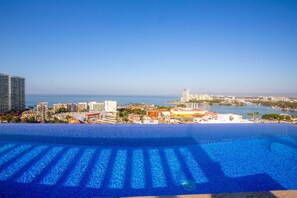 A pool with a clear view of the ocean and cityscape. - Soho Skies 204 Stunning Sunset - Ocean Views wit (Puerto Vallarta)