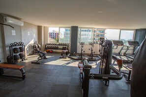 A gym with various exercise equipment, including treadmills, weight machines, and free weights. - Soho Skies 204 Stunning Sunset - Ocean Views wit (Puerto Vallarta)