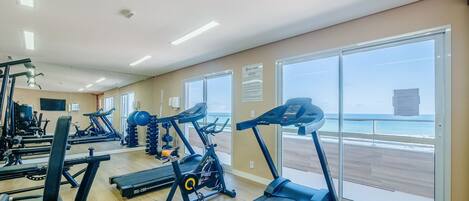A gym with treadmills, exercise bikes, and weight machines.