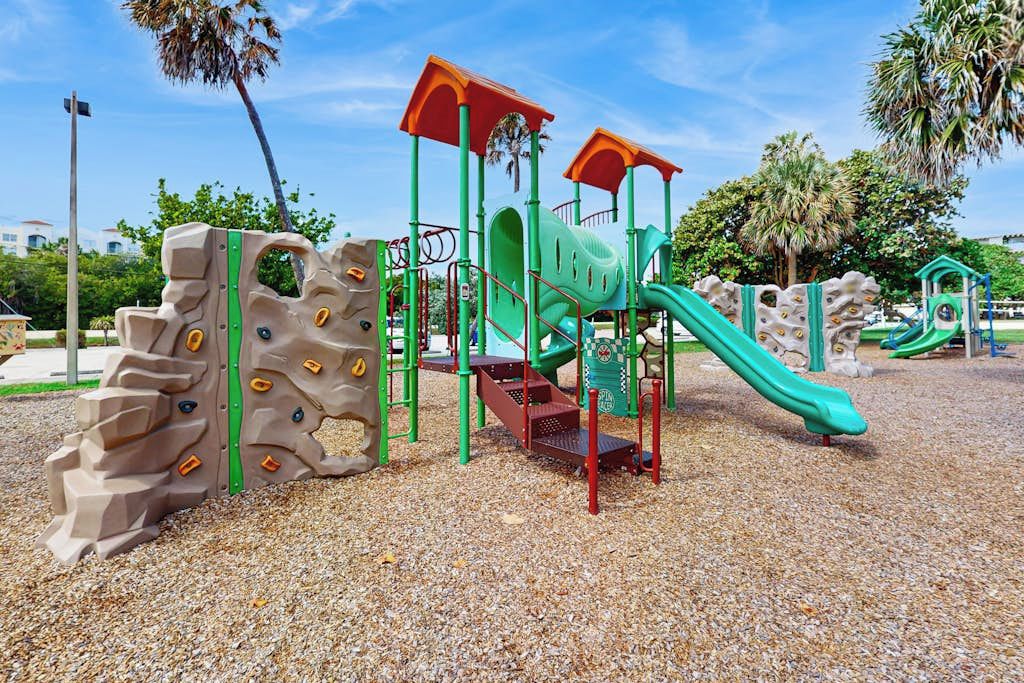 A playground with climbing structures and slides.