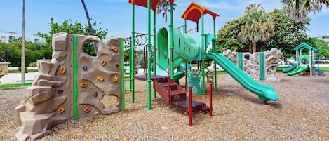 A playground with climbing structures and slides.