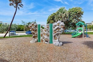 A playground with climbing structures and a slide. - Azure Haven - Private Pool (Lantana)
