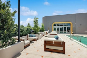 A poolside area with outdoor seating and a building entrance. - NoMad #628 - Private Balcony (Miami)