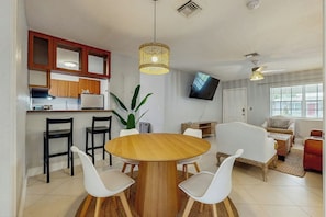 A compact living space with a kitchen, dining area, and seating area. - The Palms Unit 1 - Enclosed Yard (Fort Lauderdale)