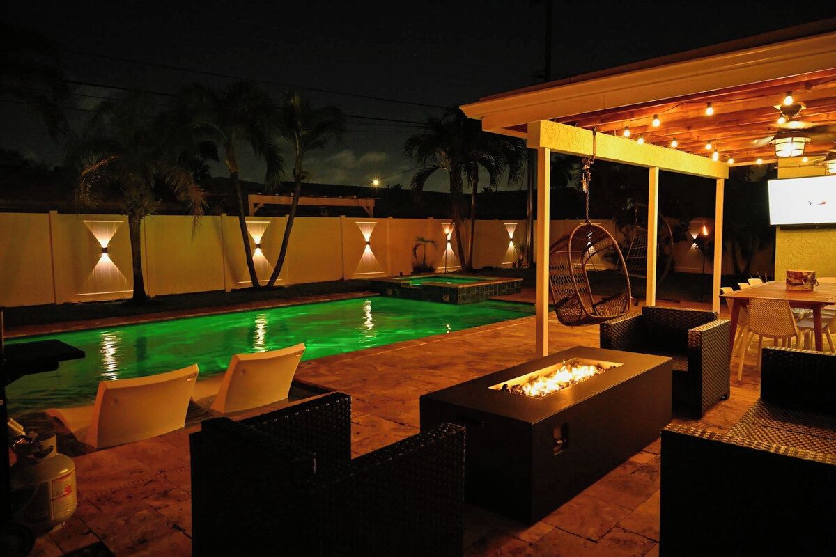 An outdoor pool area with a fire pit and seating.