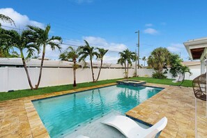 A swimming pool with a clear blue water, surrounded by a tiled deck and palm trees. - Terrace 17 - Private Pool (Fort Lauderdale)