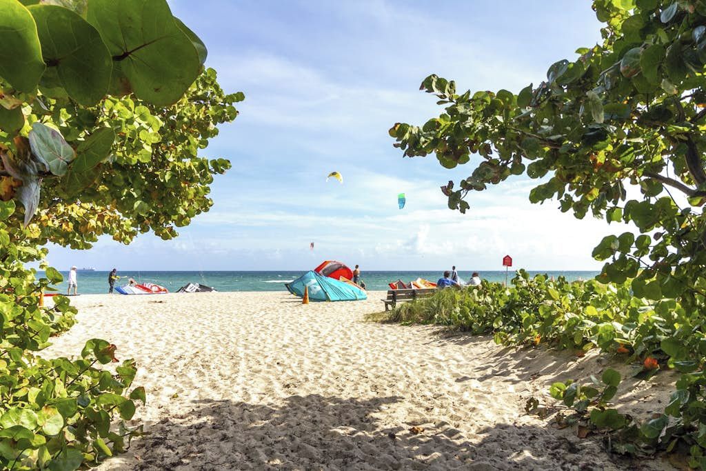 Une plage avec une tente et des personnes au loin.