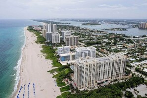 A coastal cityscape with high-rise buildings, a beach, and a marina. - Singer Island Serenity (West Palm Beach)