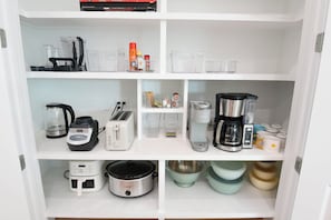 A kitchen with various appliances and utensils, including a coffee maker, toaster, and blender. - Most Kid-Friendly 30A Home + Private Heated Pool + Golf Cart + All Beach Gear (Inlet Beach)