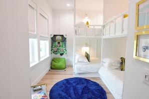 A child's room with bunk beds, a green bean bag, and a LEGO play mat. - Most Kid-Friendly 30A Home + Private Heated Pool + Golf Cart + All Beach Gear (Inlet Beach)