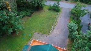 A green lawn with a gravel path leading to a wooden deck. - Updated Glacier Springs Basecamp w Grill (Deming)