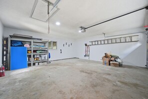 A spacious garage with a workbench, shelving, and various tools. - Yuppie Buck |  2mi to Ski Resort, Stunning Views & Game Room (Beech Mountain)