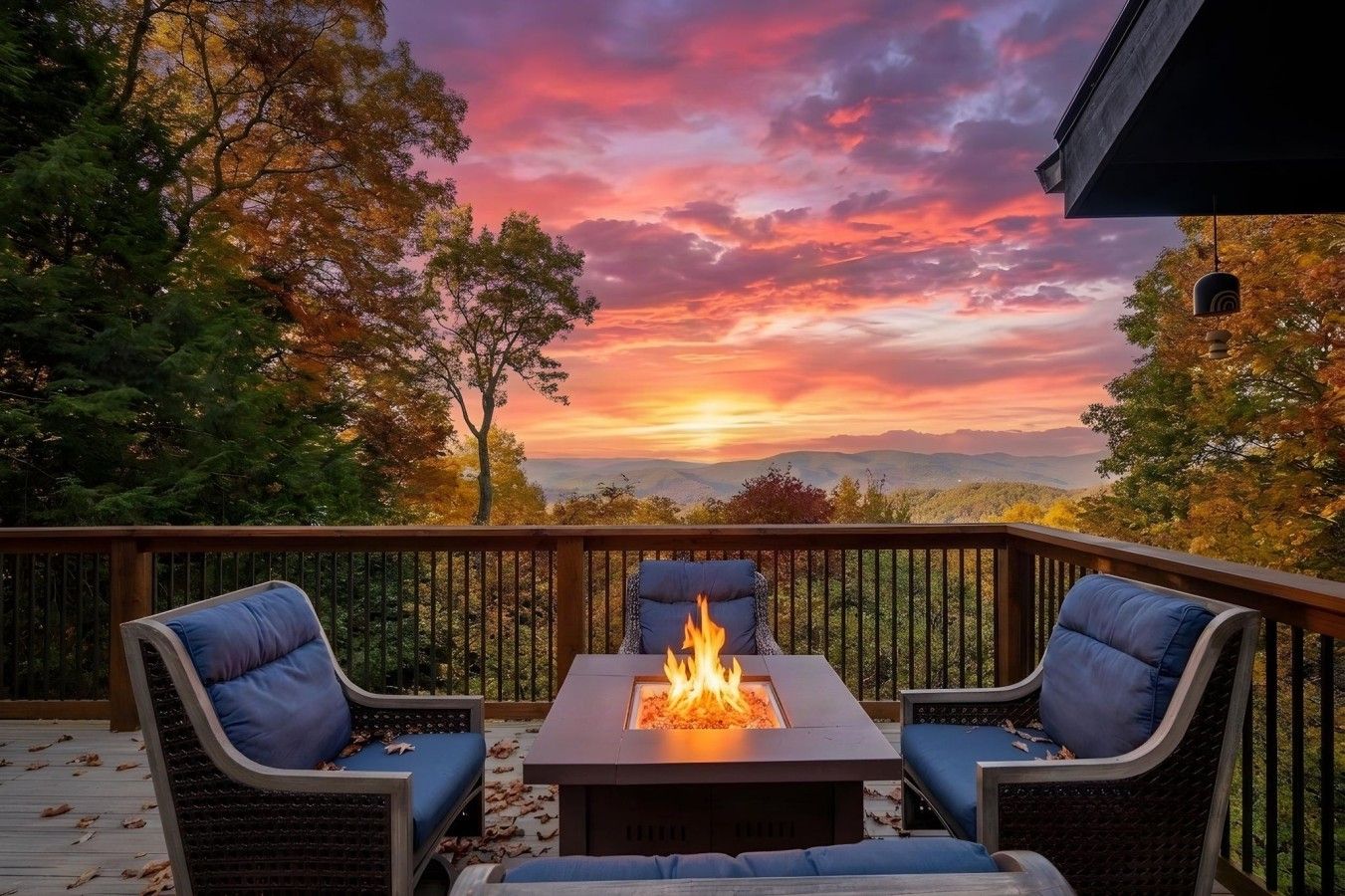 A deck with a fire pit and two chairs, overlooking a scenic landscape.