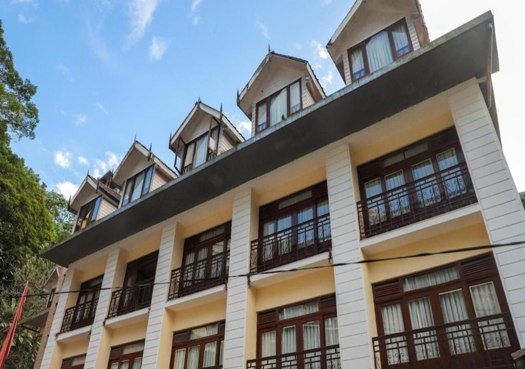 A multi-story building with balconies and large windows.