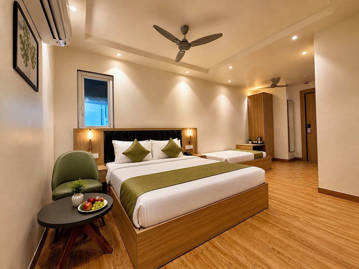 A hotel room with a large bed, a desk, a chair, and a ceiling fan.