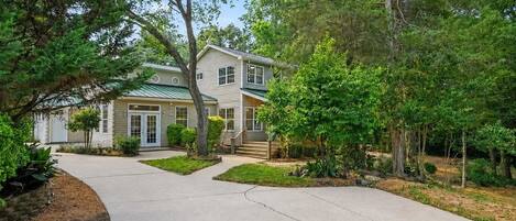 A two-story house with a front yard and a driveway.