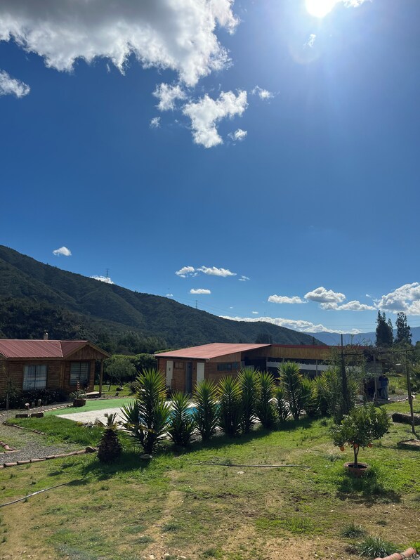 A residential area with houses, a clear sky, and a mountain in the background.