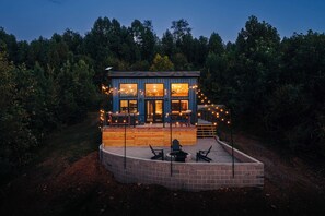 A modern house with a deck, surrounded by trees. - The Overlook A Luxury Cabin With Hot Tub And Views (New Plymouth)
