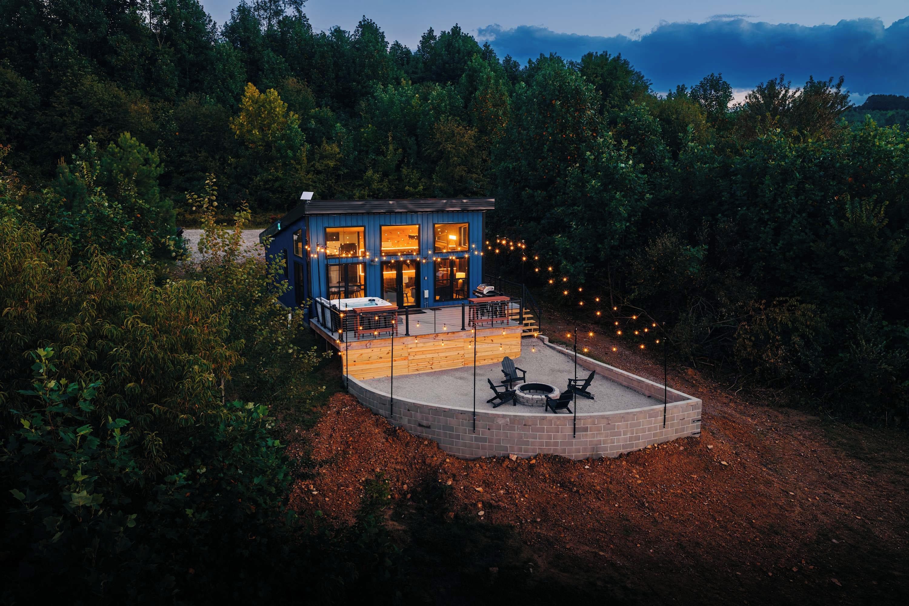 A two-story building with a deck and a fire pit area.