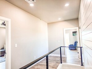 A staircase with a handrail leading to a landing. - NEW Longtown Lakefront Retreat | Boat Slip | Game Room | Sleeps 10 (Eufaula)