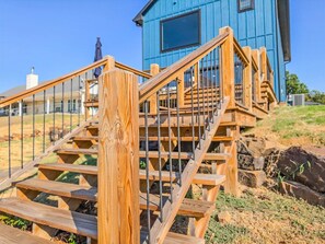 A wooden staircase leading to a blue building with a metal railing. - NEW Longtown Lakefront Retreat | Boat Slip | Game Room | Sleeps 10 (Eufaula)