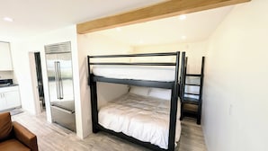 A bunk bed with a kitchen area and a refrigerator. - Beach Front - Studio Condo, Luxury Finishes, Walk to Everything, 440 sq ft, WIFI (Huntington Beach)