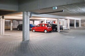 An underground parking garage with multiple cars parked. - Idyllic 1-bedroom apartment, sauna, national park, parking (Zwiesel)