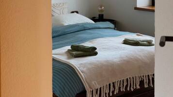 Une chambre à coucher avec un lit, une table de chevet, une lampe et un miroir.
