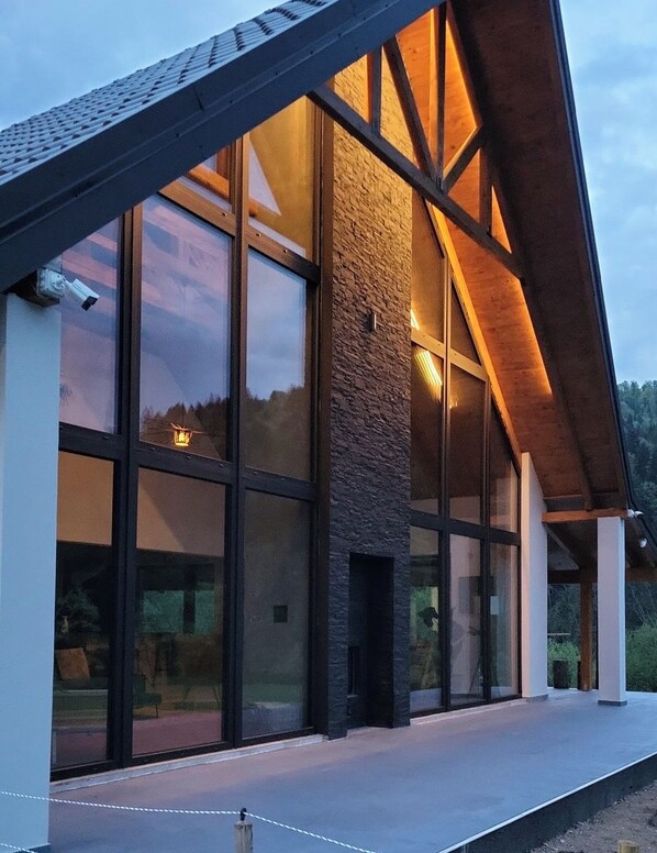 A modern building with large windows and a sloped roof.