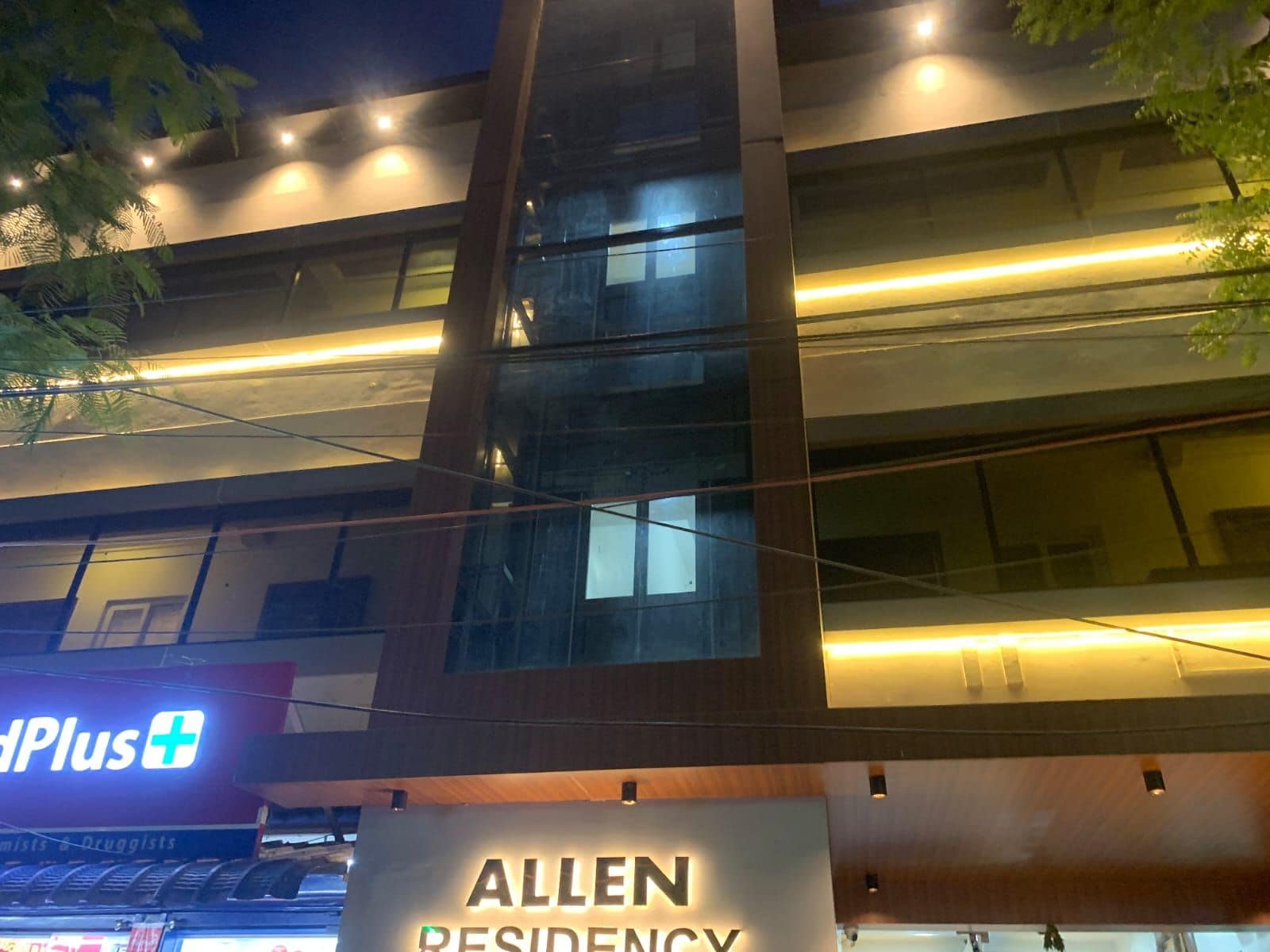 A multi-story building with a sign for 'Allen Residency.'
