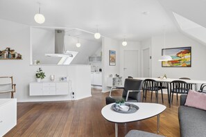 Espaço moderno com área de jantar, cozinha e sala de estar.